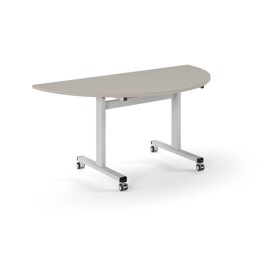 Semi-circular table with light grey top and metal legs with wheels on a white background