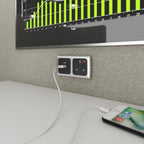 Power unit with a cable and phone in a close up office setting