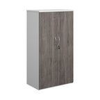 Lockable office cupboard with grey wood-effect doors and silver handles, shown on a white background.