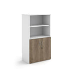 Office storage cupboard with a white carcass, open upper shelving, and lockable lower wood-effect doors, shown on a white background.