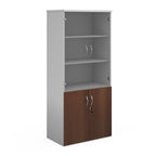 Tall office storage cupboard with a white carcass, lockable lower dark wood-effect doors, and upper glass display doors with internal shelving, shown on a white background.
