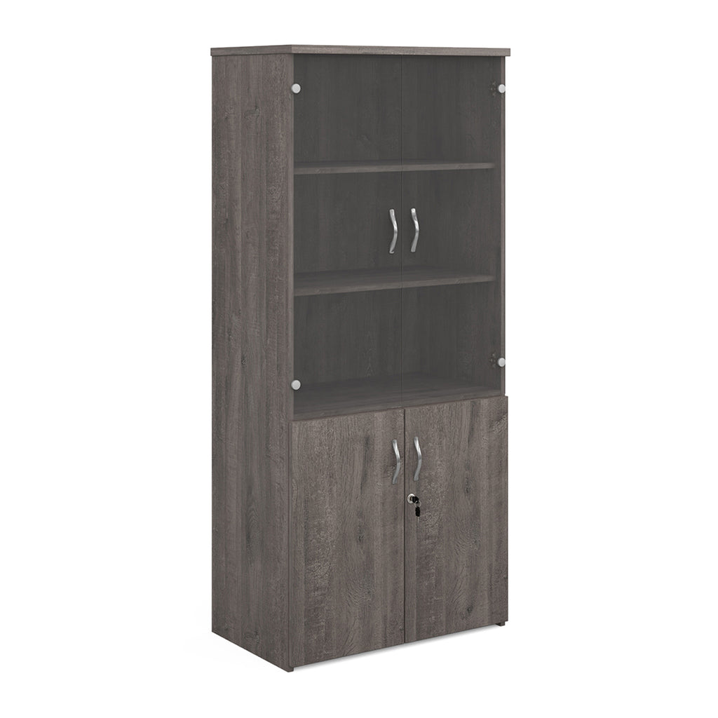 Tall office storage cupboard with a grey wood-effect carcass, lockable lower doors, and upper glass display doors with internal shelving, shown on a white background.