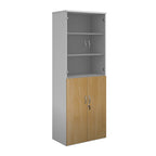 Tall office storage cupboard with a white carcass, lockable lower wood-effect doors, and upper glass display doors with internal shelving, shown on a white background.