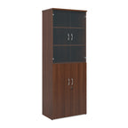 Tall office storage cupboard with a dark wood-effect carcass, lockable lower doors, and upper glass display doors with internal shelving, shown on a white background.