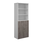Tall office storage cupboard with a white carcass, open upper shelving, and lockable lower grey wood-effect doors, shown on a white background.