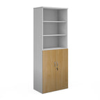 Tall office storage cupboard with a white carcass, open upper shelving, and lockable lower wood-effect doors, shown on a white background.