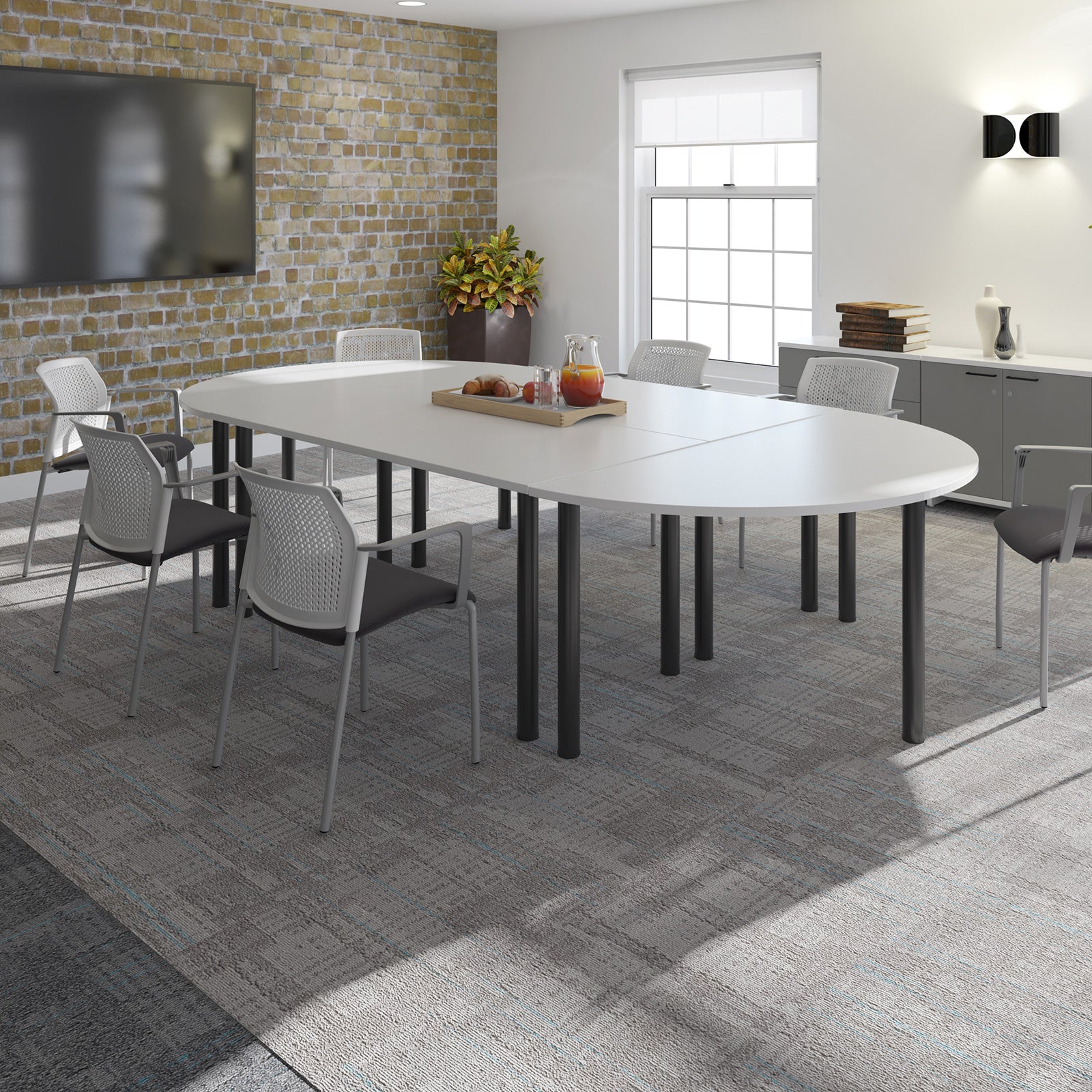 Modern conference room with a large oval table and chairs.