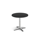 Round black table with metal base on a white background