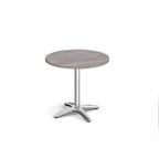 Round wood-effect table with metal base on a white background