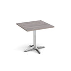 Square table with a grey wood-effect top and chrome base on a white background