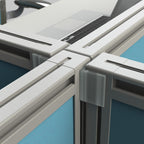 Close-up of office cubicle partitions with blue walls and gray frames.