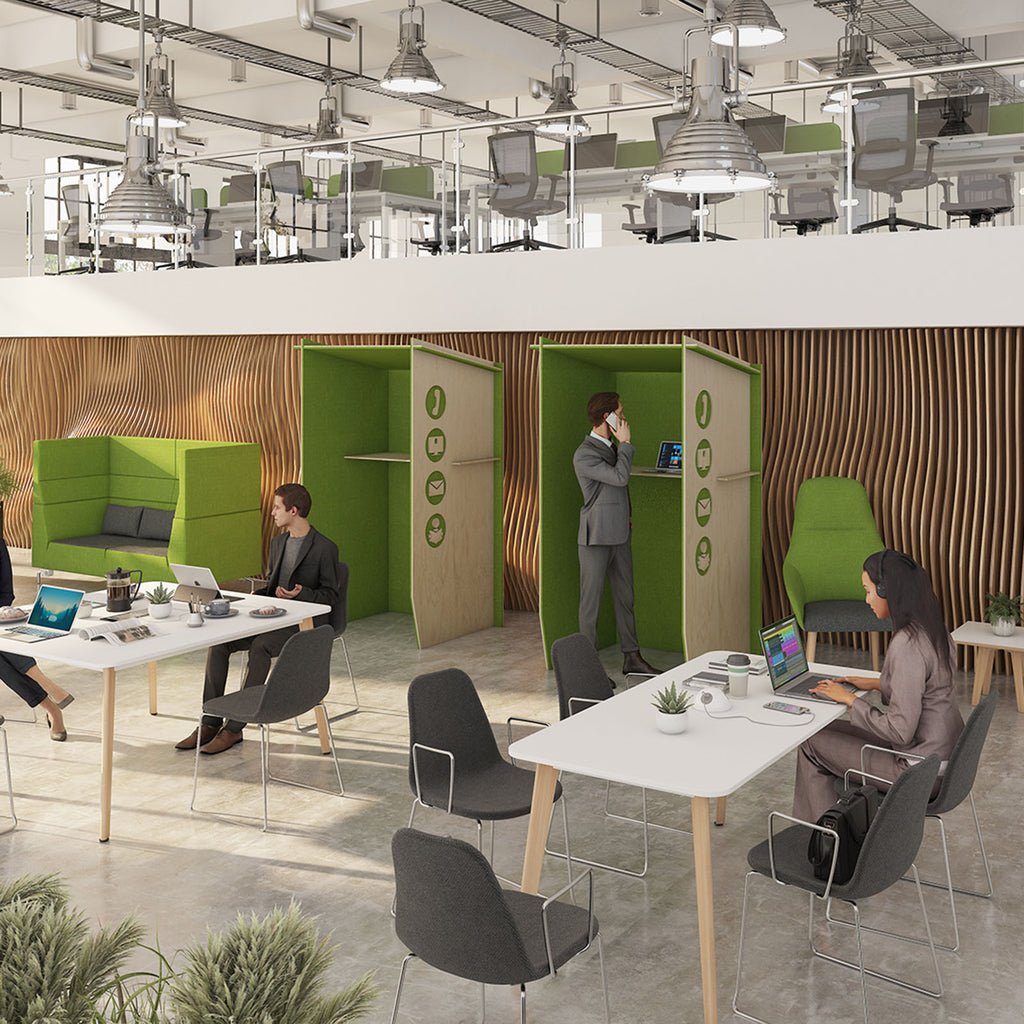 Modern collaborative office with acoustic phone booths, shared work tables, lounge seating, and open mezzanine workspace above.