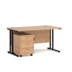 Wooden office desk with black legs and a pedestal unit on a white background