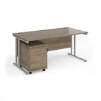 Wooden office desk with metal legs and a drawer unit on a white background