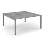 Square table with a grey wooden top and metal frame on a white background