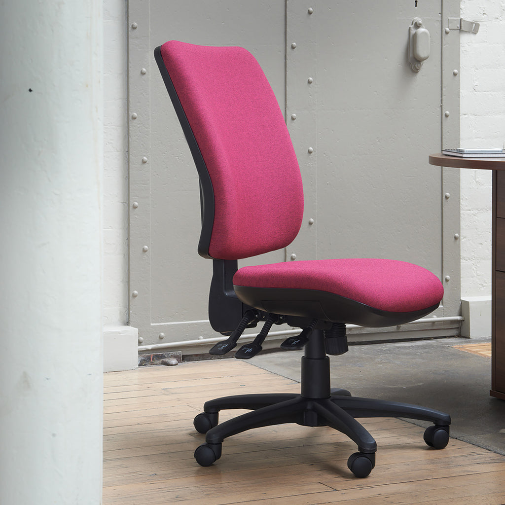 Pink office chair with black base in a room with a metallic wall.