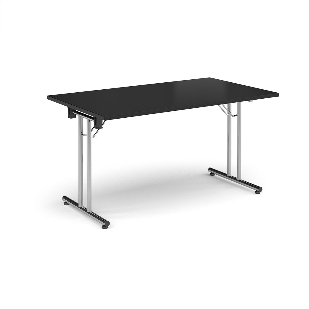 Folding table with black top and metal legs on a white background