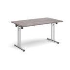 Folding table with grey wood-effect top and metal legs on a white background