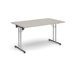Folding table with light grey top and metal legs on a white background