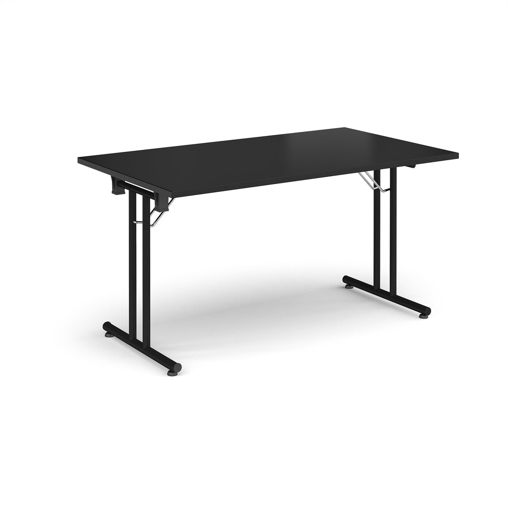 Folding table with black top and metal legs on a white background