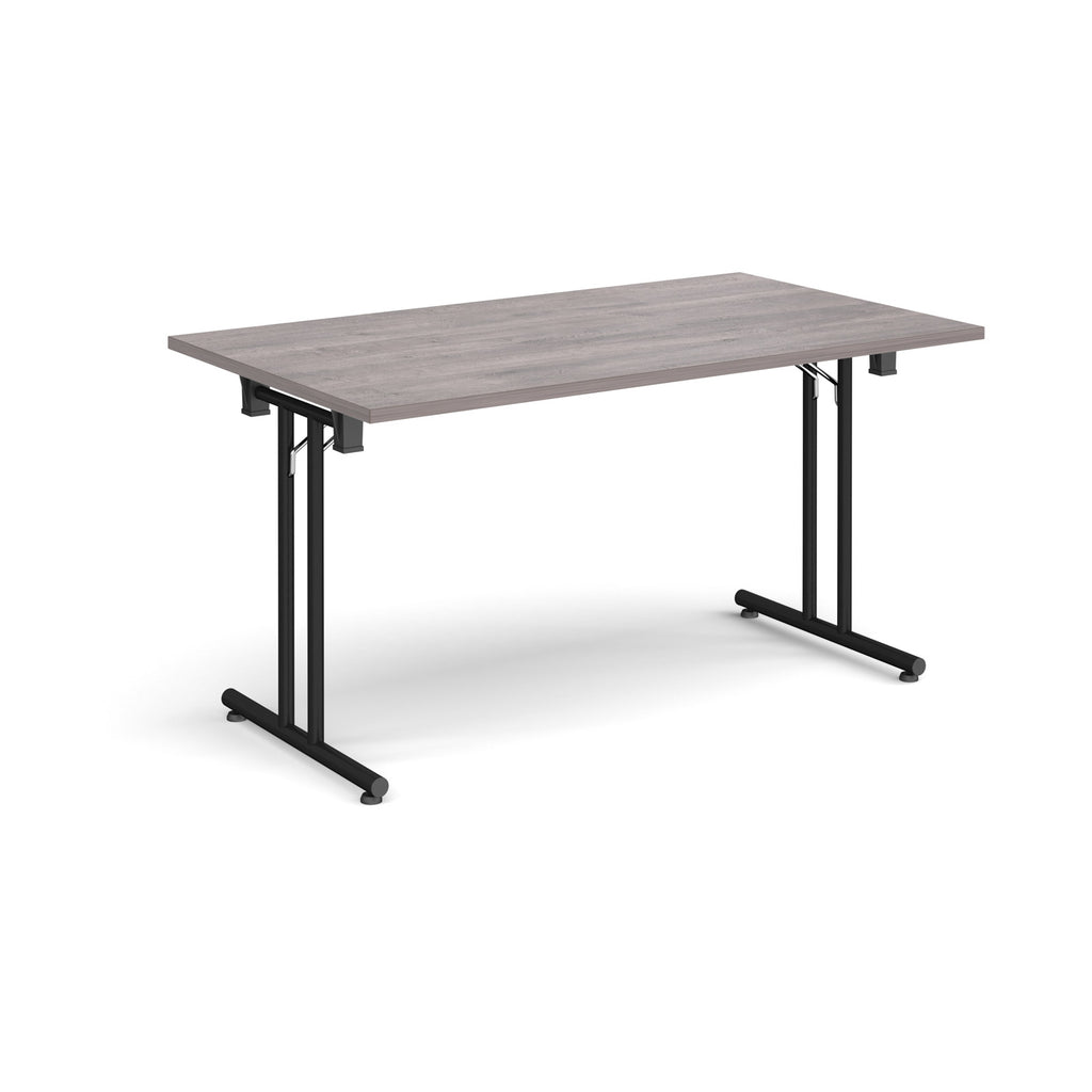Folding table with grey wood-effect  top and black metal legs on a white background