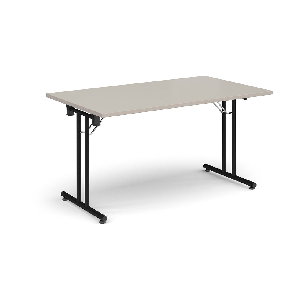 Folding table with light grey top and black metal legs on a white background