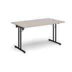 Folding table with light grey top and black metal legs on a white background