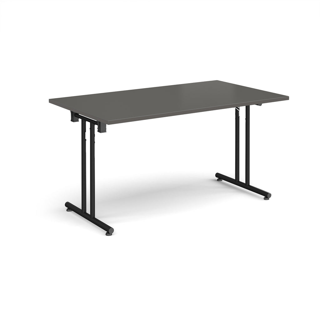 Folding table with grey top and black metal legs on a white background