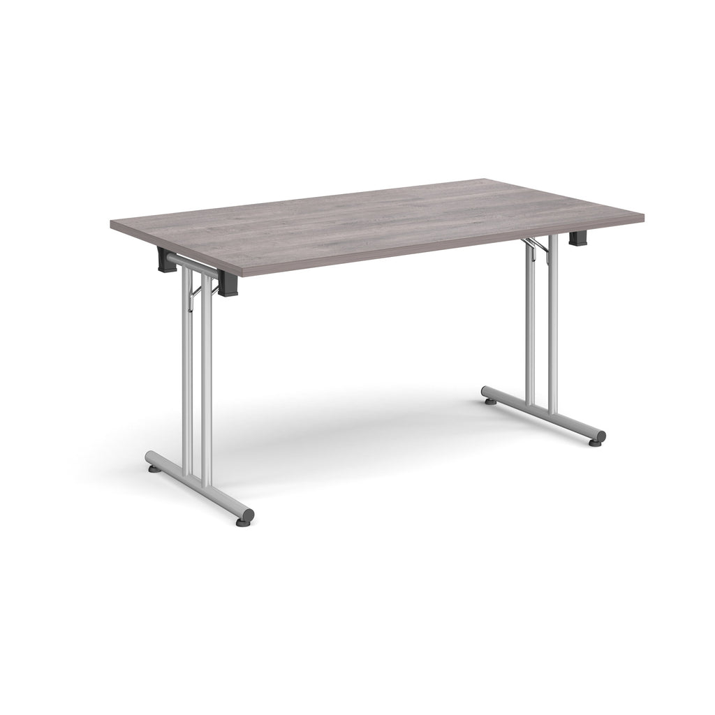 Folding table with grey wood-effect top and metal legs on a white background