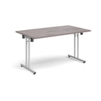 Folding table with grey wood-effect top and metal legs on a white background