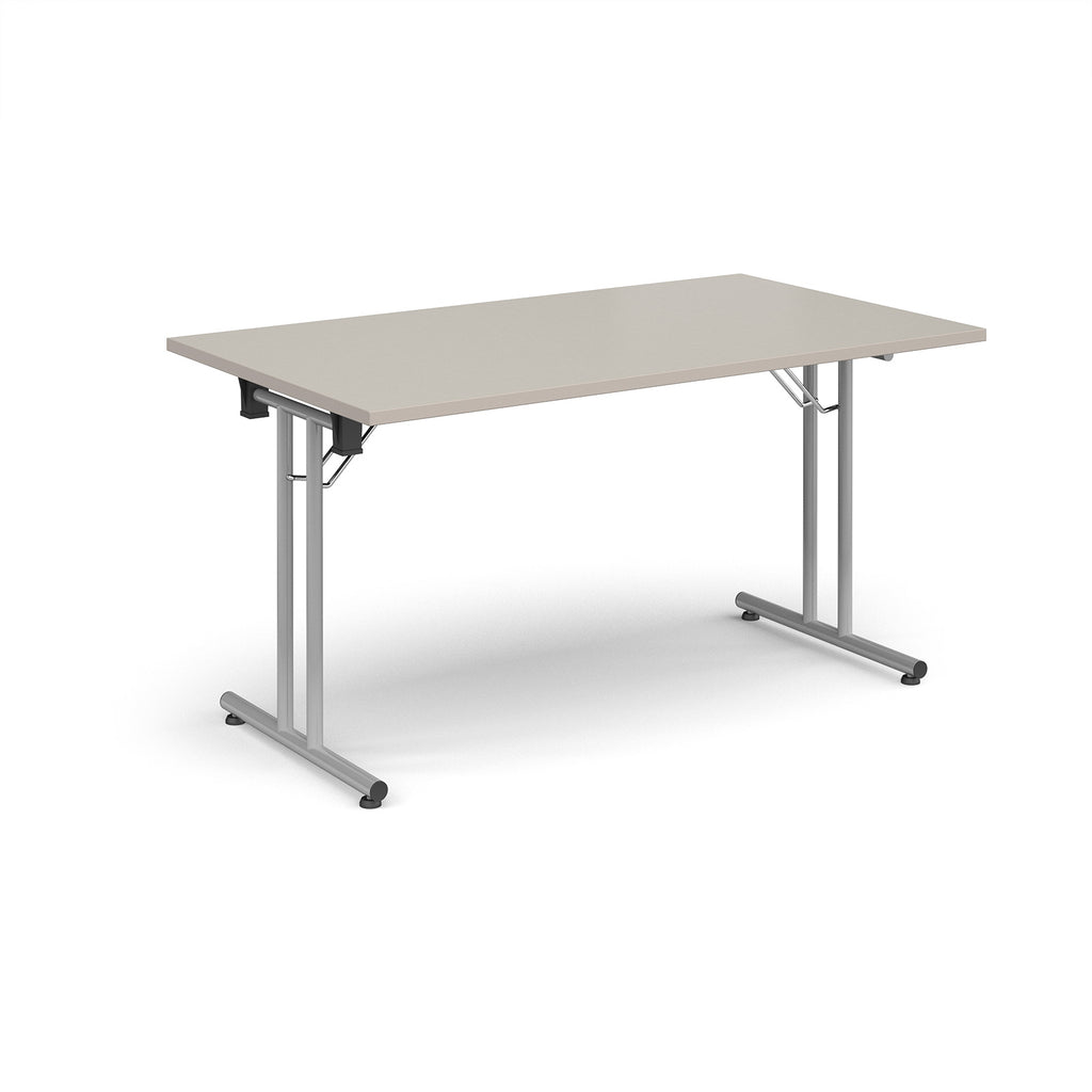 Folding table with light grey top and metal legs on a white background