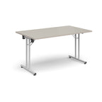Folding table with light grey top and white metal legs on a white background
