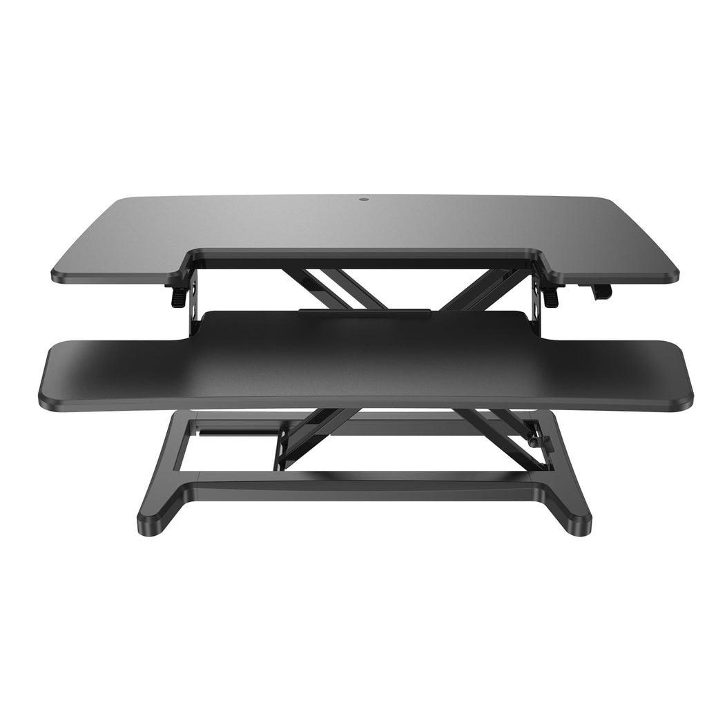 Height-adjustable sit-stand desk converter with two-tier work surface and scissor-lift frame, shown against a white background.