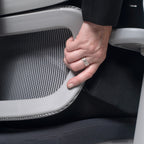 Close-up of a hand adjusting the lumbar support on a mesh ergonomic office chair, demonstrating personalised back support control.
