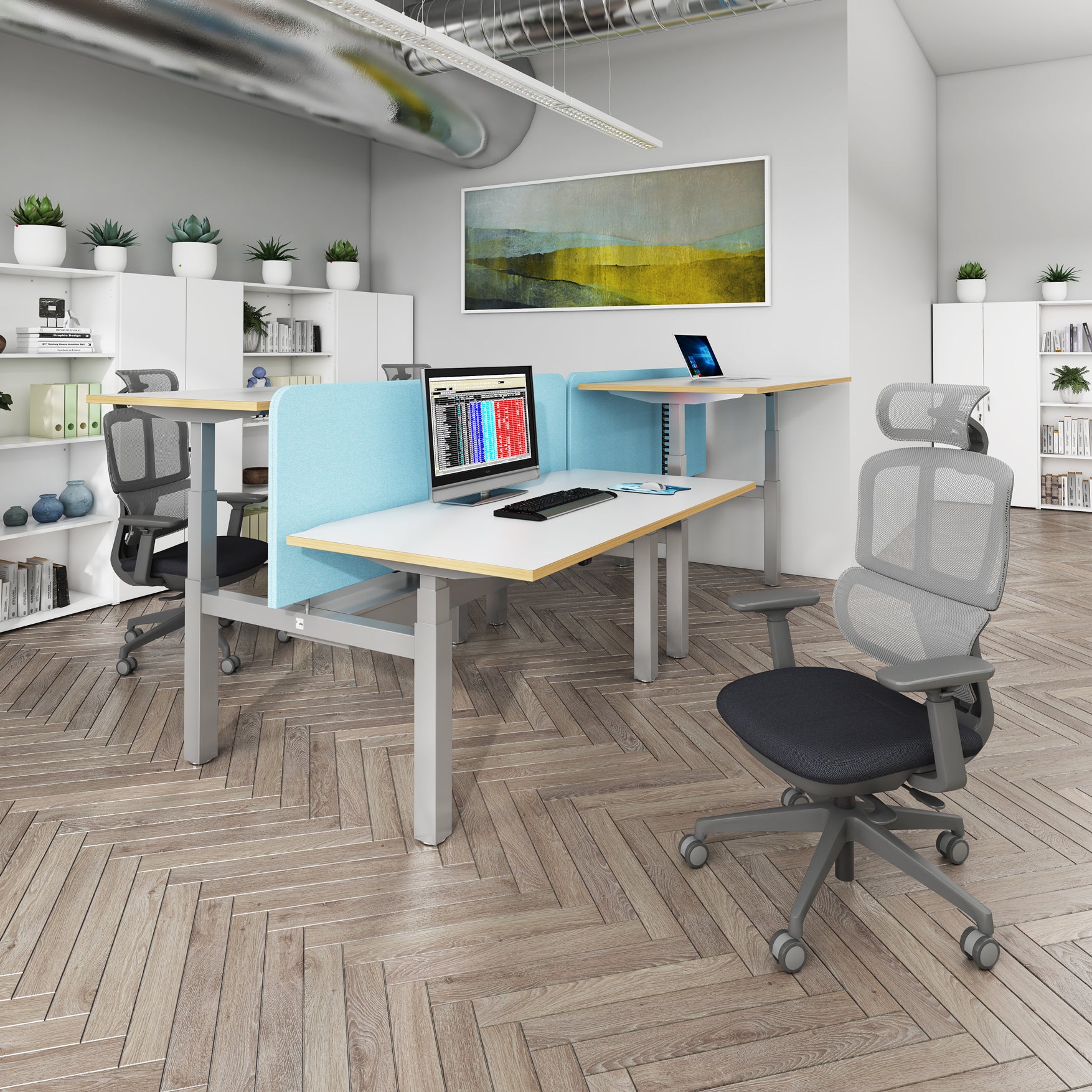 Modern office setup with desks, chairs, and a computer in a well-lit room.