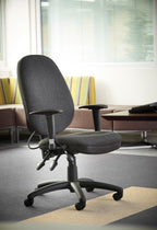 Grey office chair in a modern office setting with a couch and window blinds.