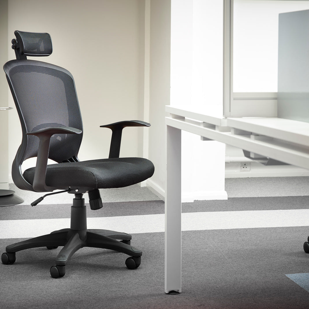 Black office chair in an office setting with a desk and computer.