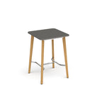 Square table with grey top, angled wooden legs, and chrome footrest bar, shown against a white background.