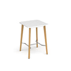 Square table with white top, angled wooden legs, and chrome footrest bar, shown against a white background.