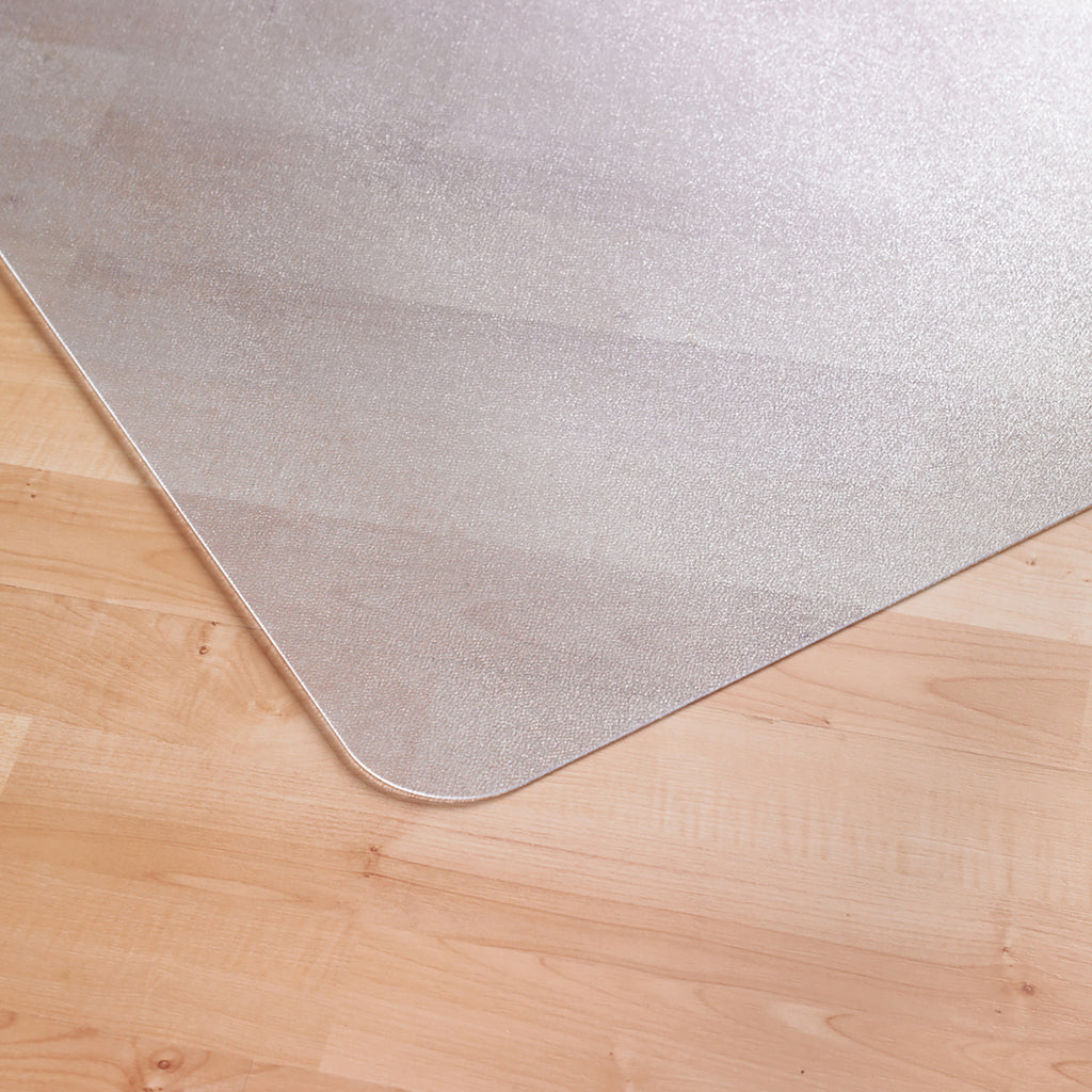 Transparent floor mat with rounded corner placed on a light wood floor, designed to protect flooring under office chairs.