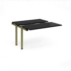 Modular bench desk add-on with a black top, integrated cable access cut-out, and green metal legs, shown on a white background.