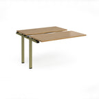 Modular bench desk add-on with a wood-effect top, integrated cable access cut-out, and green metal legs, shown on a white background.