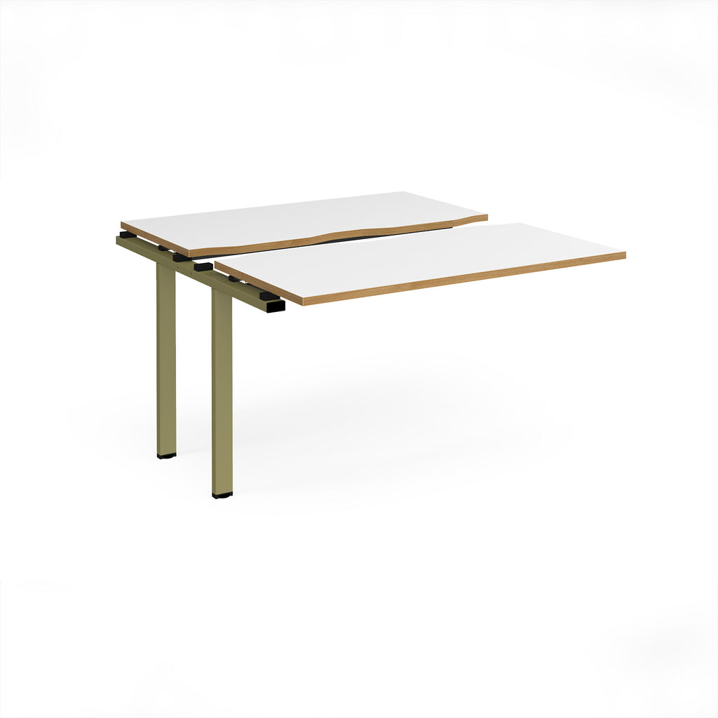 Modular bench desk add-on with white top with wood-effect edging, integrated cable access cut-out, and green metal legs, shown on a white background.