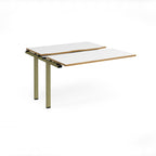 Modular bench desk add-on with white top with wood-effect edging, integrated cable access cut-out, and green metal legs, shown on a white background.