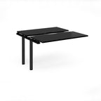 Modular bench desk add-on with a black top, integrated cable access cut-out, and black metal legs, shown on a white background.