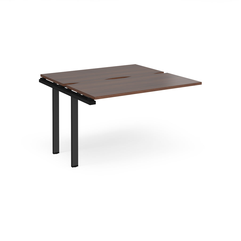 Modular bench desk add-on with a dark wood-effect top, integrated cable access cut-out, and black metal legs, shown on a white background.