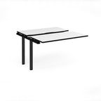 Modular bench desk add-on with a white top with black edging, integrated cable access cut-out, and black metal legs, shown on a white background.
