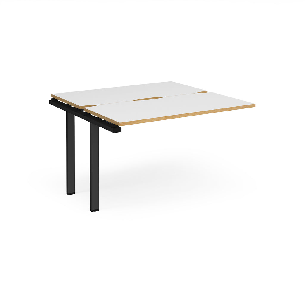 Modular bench desk add-on with white top with wood-effect edging, integrated cable access cut-out, and black metal legs, shown on a white background.