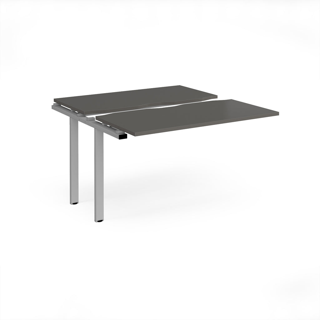 Modular bench desk add-on with a grey top, integrated cable access cut-out, and silver metal legs, shown on a white background.