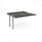 Modular bench desk add-on with a grey top, integrated cable access cut-out, and silver metal legs, shown on a white background.